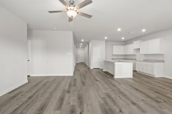 a view of kitchen with granite countertop cabinets and wooden floor