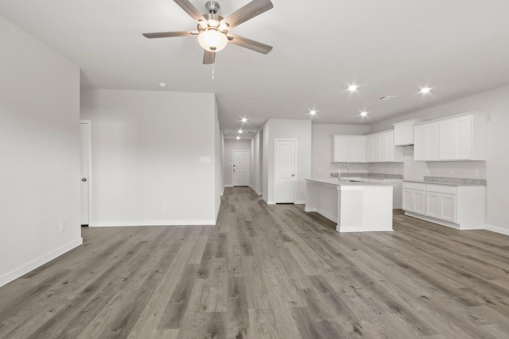 496 Shoreview Drive Conroe, TX 77303 - Photo 4 of 20 a view of kitchen with granite countertop cabinets and wooden floor