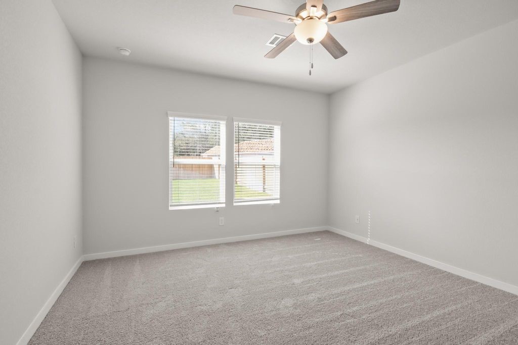 496 Shoreview Drive Conroe, TX 77303 - Photo 7 of 20 an empty room with a window and a fan