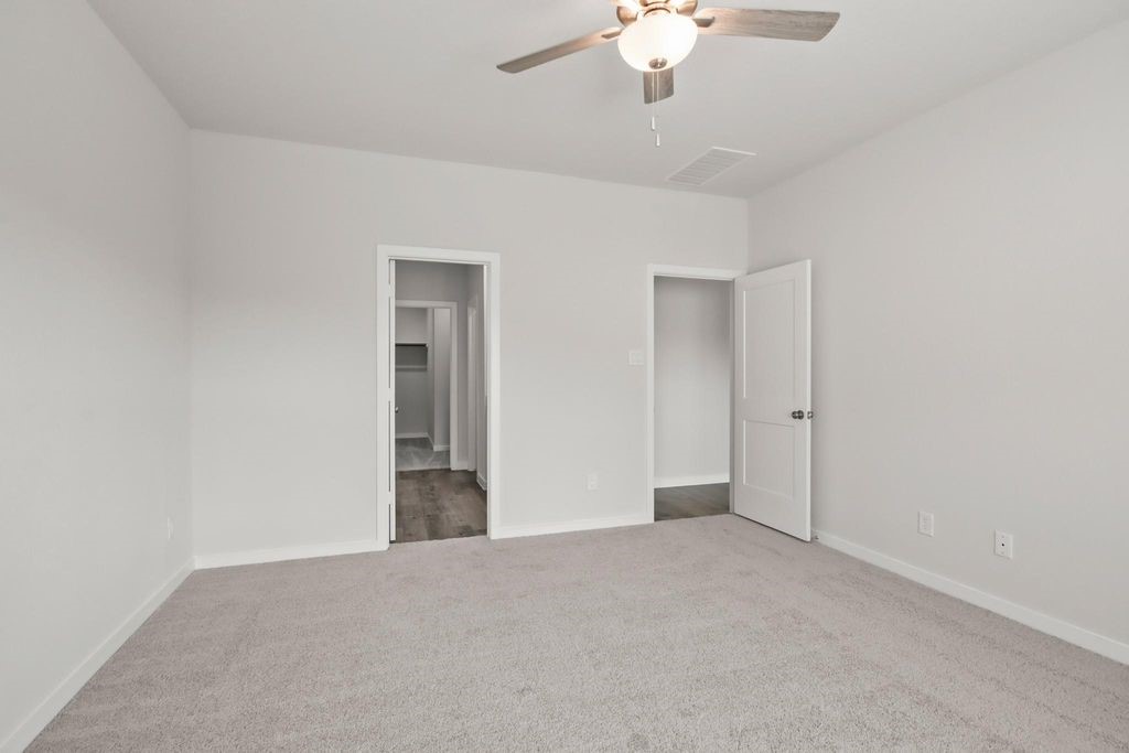 496 Shoreview Drive Conroe, TX 77303 - Photo 8 of 20 a view of an empty room with a chandelier fan