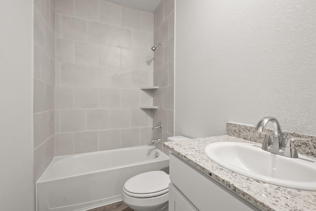 496 Shoreview Drive Conroe, TX 77303 - Photo 10 of 20 a bathroom with a granite countertop toilet a sink and a bathtub