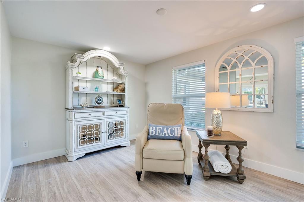 1410 Curlew Avenue Naples, FL 34102 - Photo 15 of 44 a view of a livingroom with furniture wooden floor windows and entryway