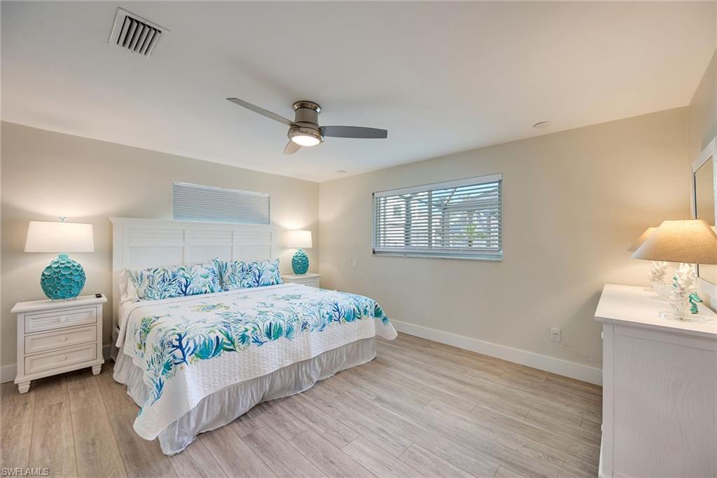 1410 Curlew Avenue Naples, FL 34102 - Photo 16 of 44 a bedroom with a large bed and a window