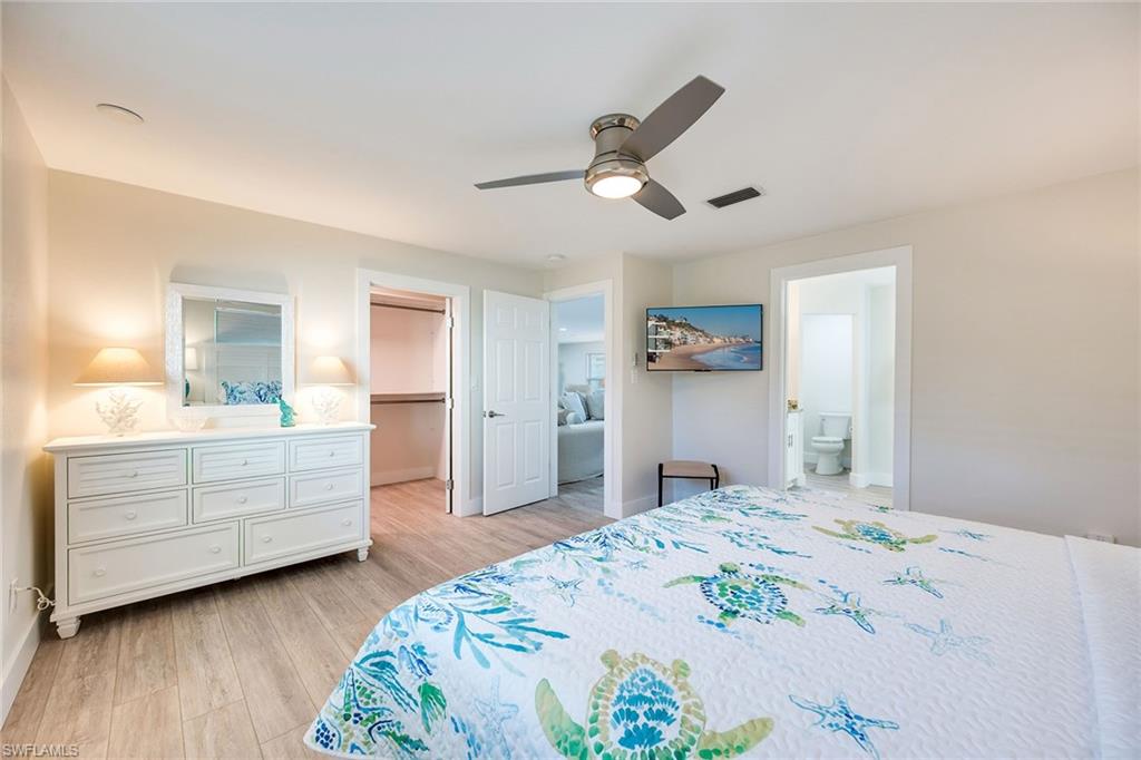 1410 Curlew Avenue Naples, FL 34102 - Photo 17 of 44 a bedroom with a bed and a dresser