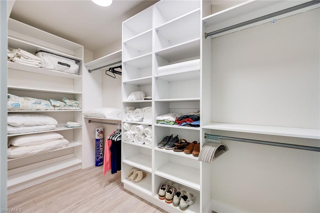 1410 Curlew Avenue Naples, FL 34102 - Photo 22 of 44 a view of walk in closet with clothes and shoes