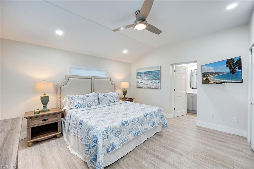 1410 Curlew Avenue Naples, FL 34102 - Photo 23 of 44 a bedroom with a bed and a chandelier