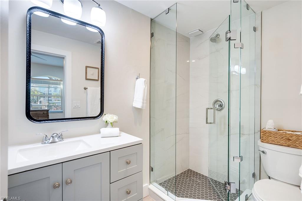 1410 Curlew Avenue Naples, FL 34102 - Photo 24 of 44 a bathroom with a toilet a sink and shower