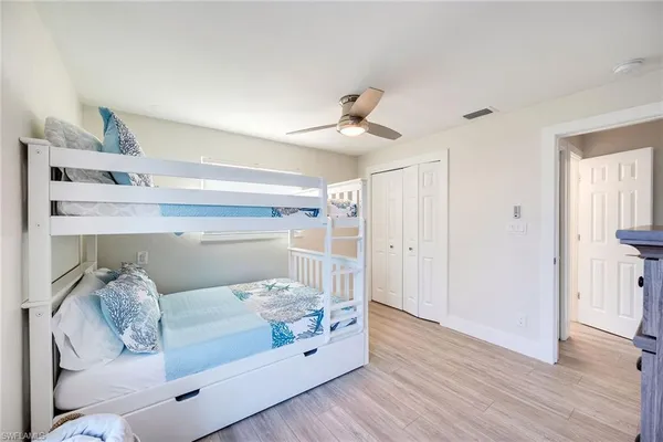 a bedroom with furniture and baby crib
