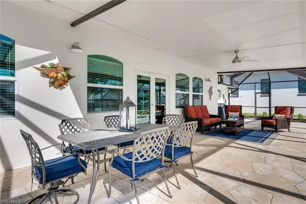 a view of a patio with a table chairs and a rug