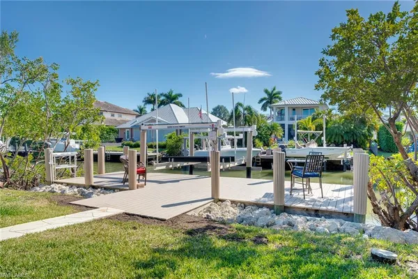 a view of a swimming pool with chairs in patio
