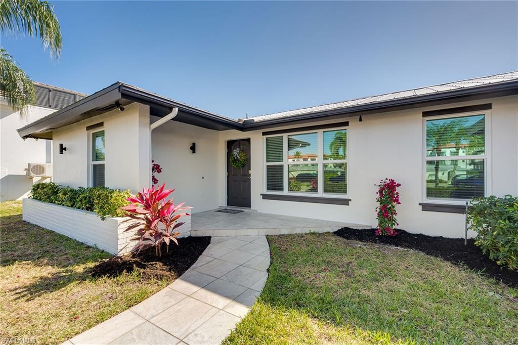 1410 Curlew Avenue Naples, FL 34102 - Photo 41 of 44 a front view of a house with a yard