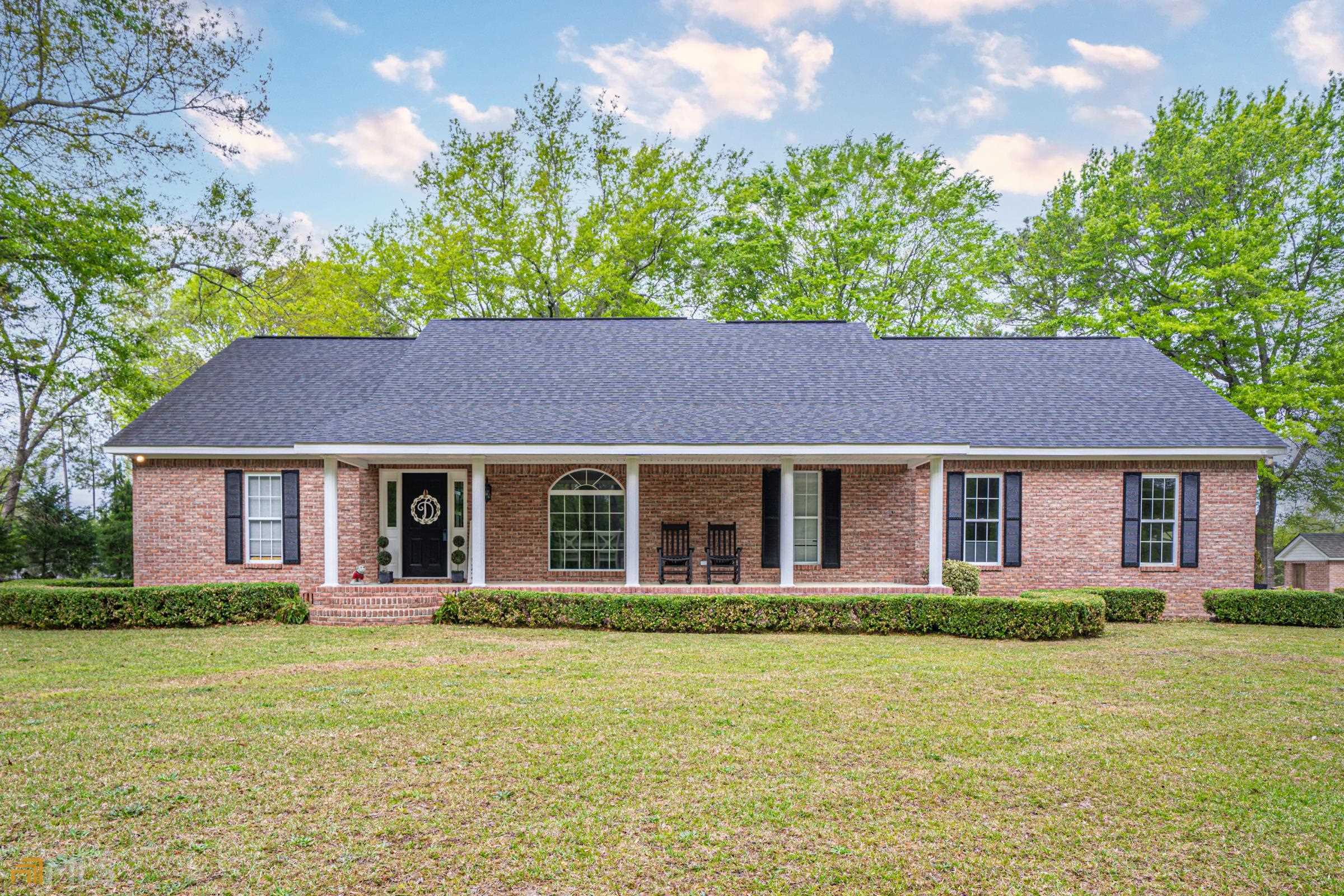 6055 Rogers Road Lizella, GA 31052 - Photo 1 of 1 a front view of a house with a garden