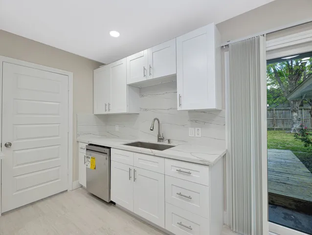 a kitchen with a sink and cabinets
