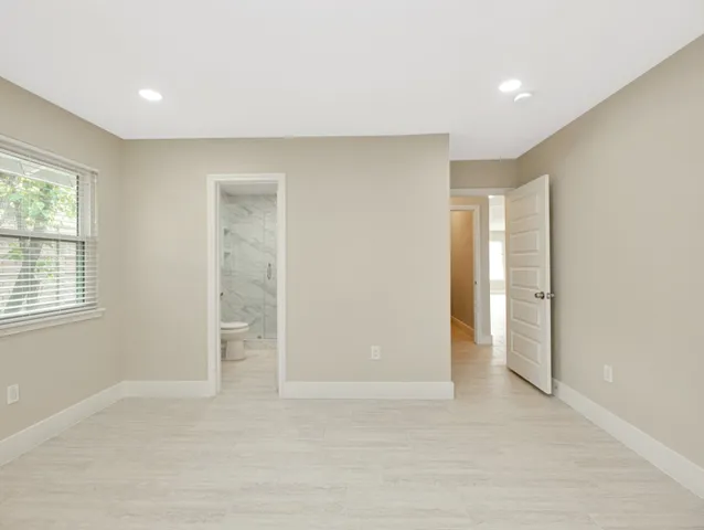 an empty room with windows and closet