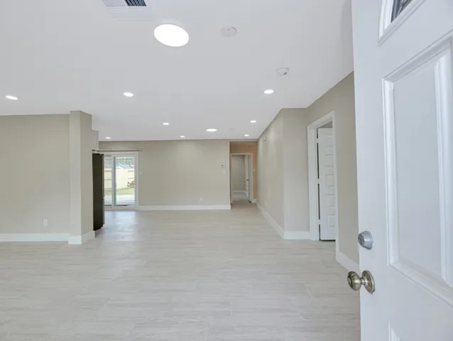 an empty room with windows and entrance