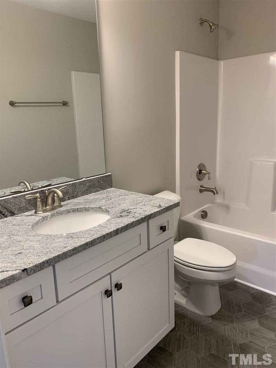7829 Creech Road Middlesex, NC 27557 - Photo 13 of 18 The hall bath has beautiful GRANITE countertops and a linen closet just outside the door!