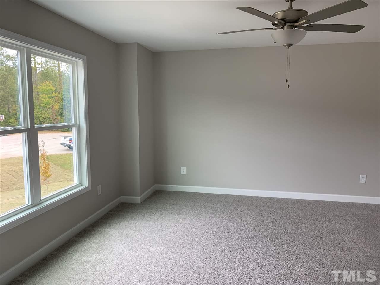 7829 Creech Road Middlesex, NC 27557 - Photo 14 of 18 The Master Bedroom offers a large walk in closet, built in entertainment cabinet, and a ceiling fan!