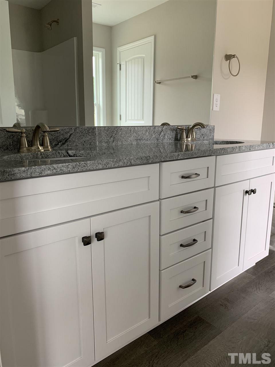 7829 Creech Road Middlesex, NC 27557 - Photo 15 of 18 The master bath offers dual vanities with GRANITE c'tops, a garden tub/ shower combination and another HUGE linen closet!