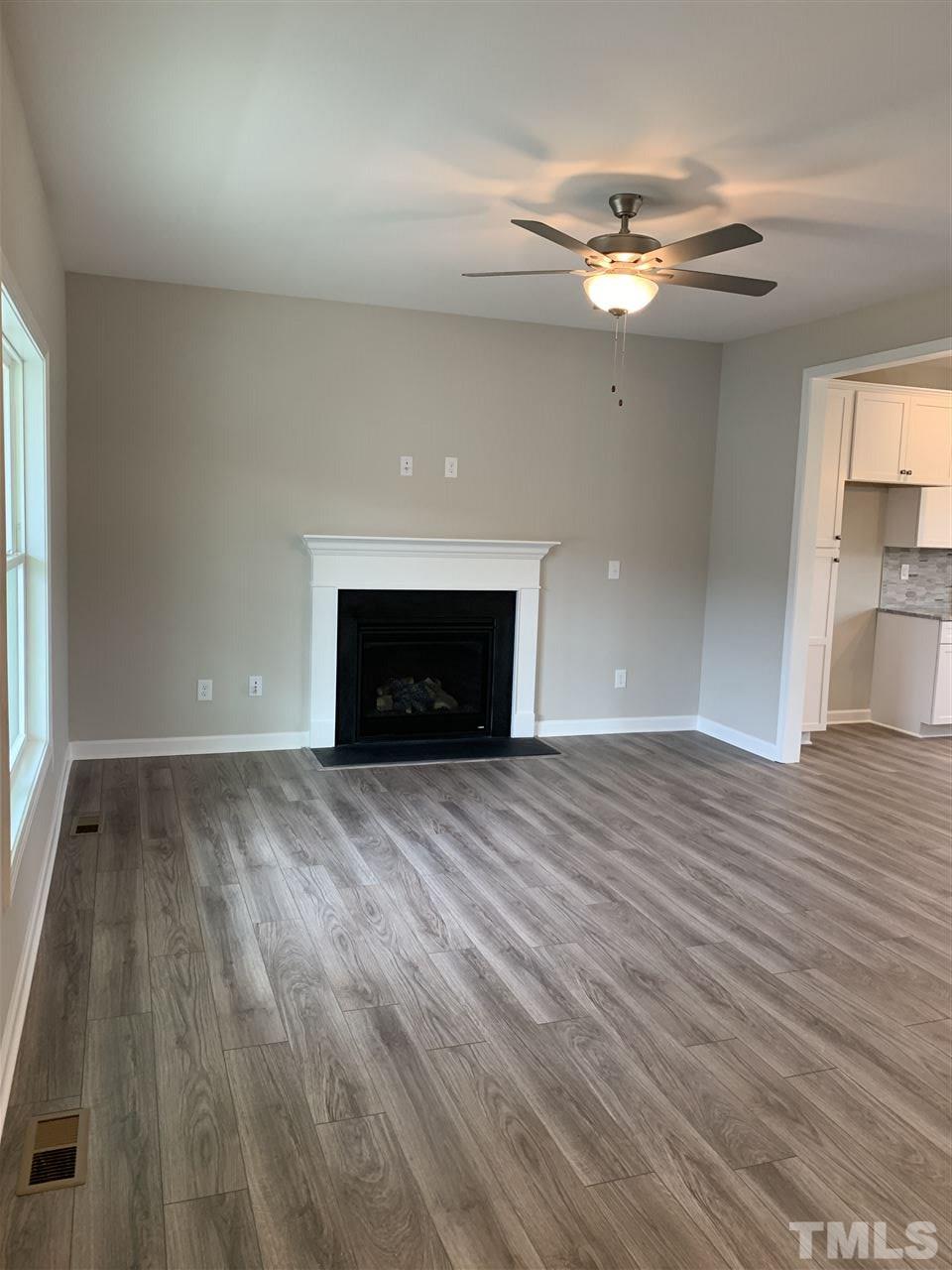 7829 Creech Road Middlesex, NC 27557 - Photo 3 of 18 The entire first floor boasts upgraded Luxury Plank flooring. The large living room also offers a gas fireplace and a ceiling fan