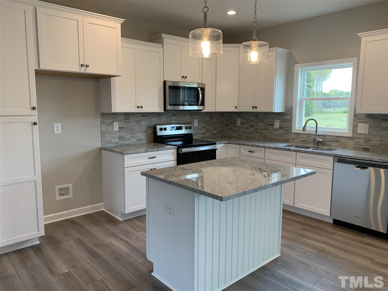 7829 Creech Road Middlesex, NC 27557 - Photo 5 of 18 This kitchen is amazing!! Tons of beautiful WHITE cabinets, UPGRADED GRANITE, recessed and pendant lighting, STAINLESS appliances and a stunning TILED BACKSPLASH. All of this plus an ISLAND and a PANTRY!!!
