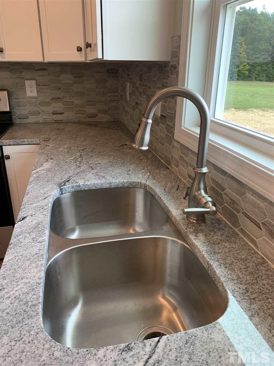 7829 Creech Road Middlesex, NC 27557 - Photo 7 of 18 Check out this gorgeous tiled backsplash as well as the deep under mounted kitchen sink
