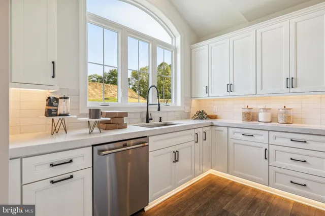 a kitchen with a sink cabinets and window