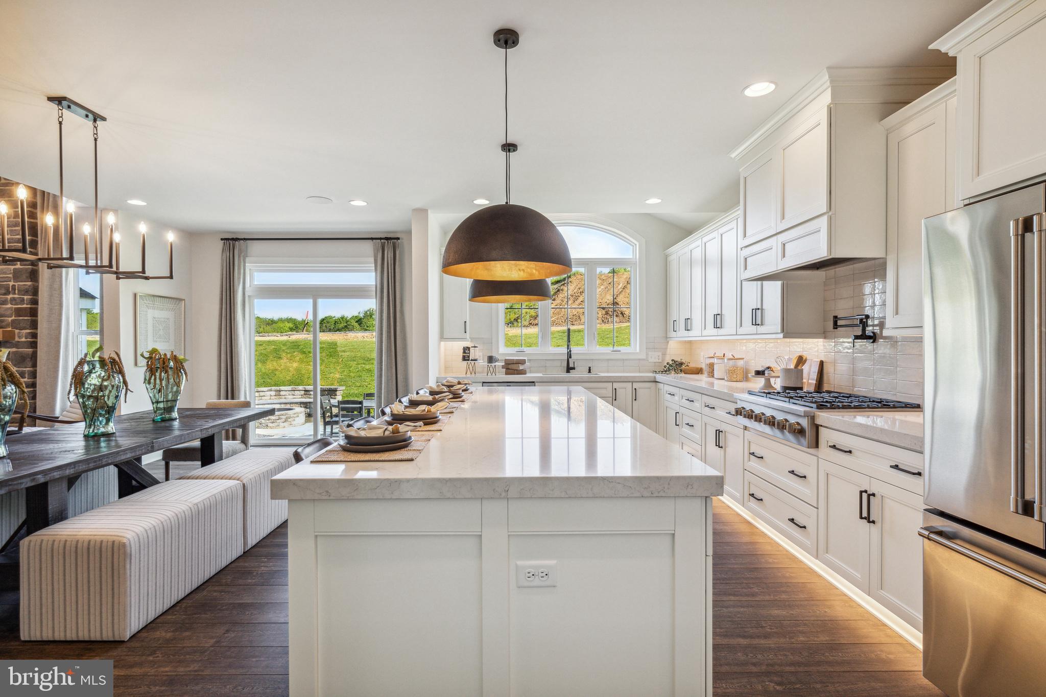 4441 Taviston Court East Emmaus, PA 18049 - Photo 20 of 49 a kitchen with stainless steel appliances granite countertop a stove a sink a center island a refrigerator and a cabinets