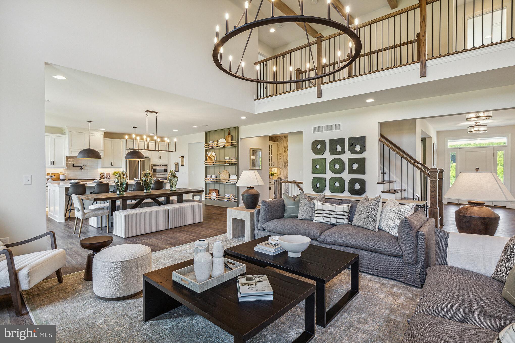 4441 Taviston Court East Emmaus, PA 18049 - Photo 25 of 49 a living room with furniture kitchen view and a chandelier