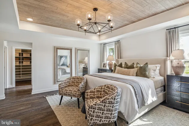 a bedroom with bed and wooden floor