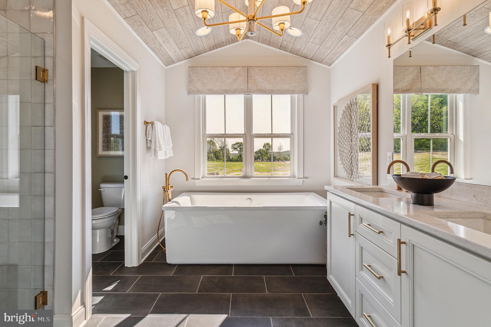 4441 Taviston Court East Emmaus, PA 18049 - Photo 30 of 49 a bathroom with a tub sink and mirror