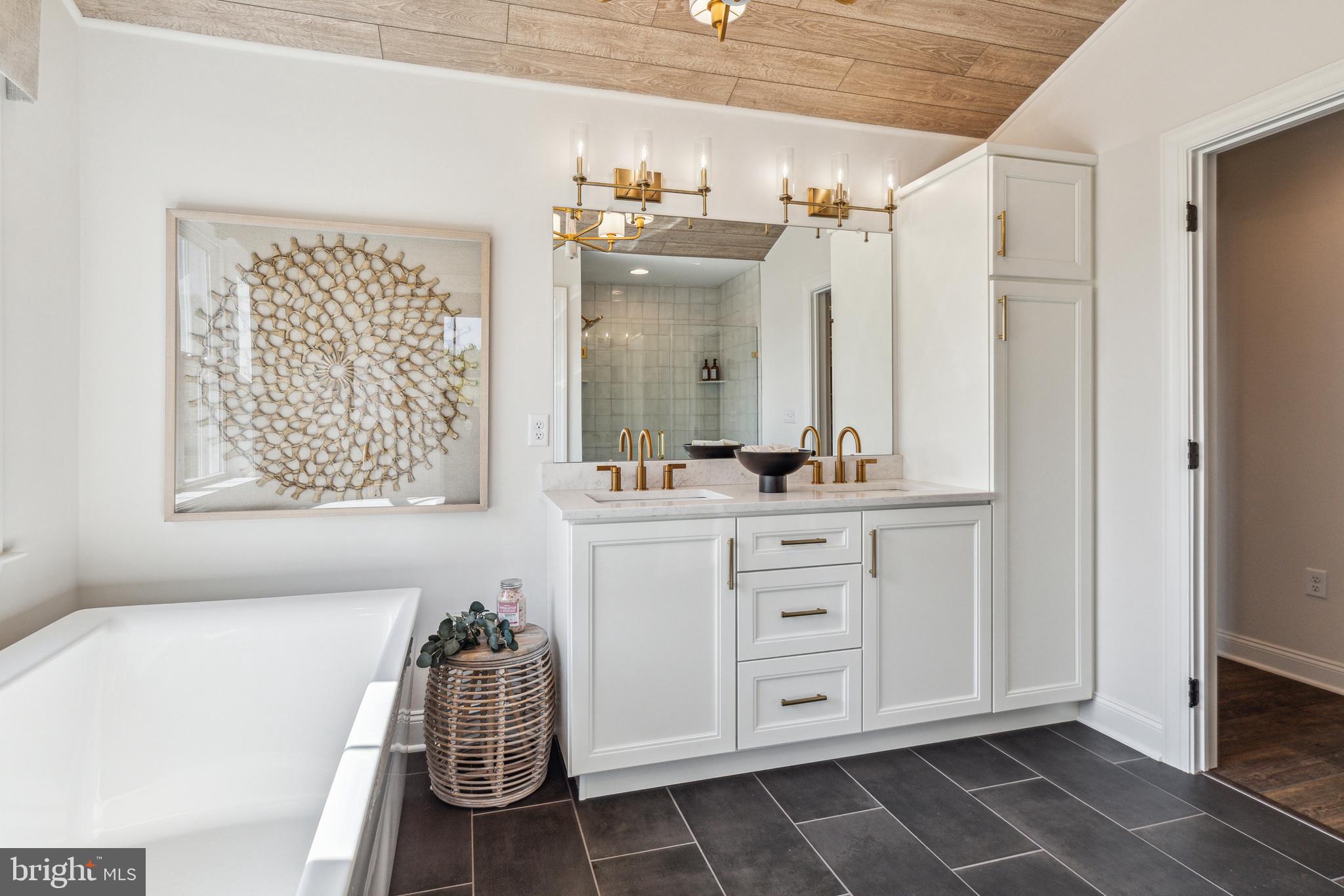 4441 Taviston Court East Emmaus, PA 18049 - Photo 32 of 49 a bathroom with a sink mirror and a bathtub