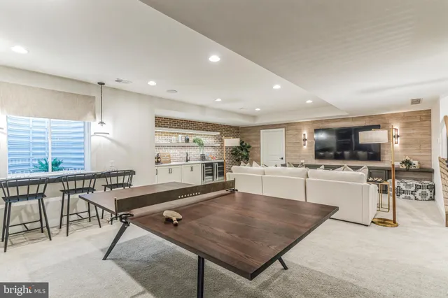 a living room with furniture a table and chairs
