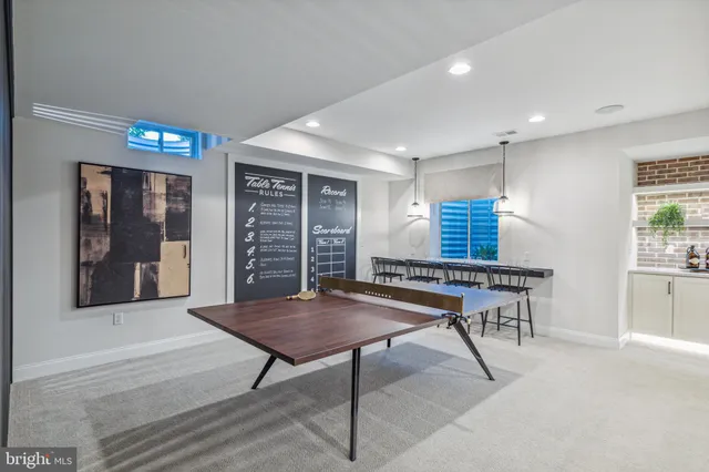 a room with furniture pool table and windows