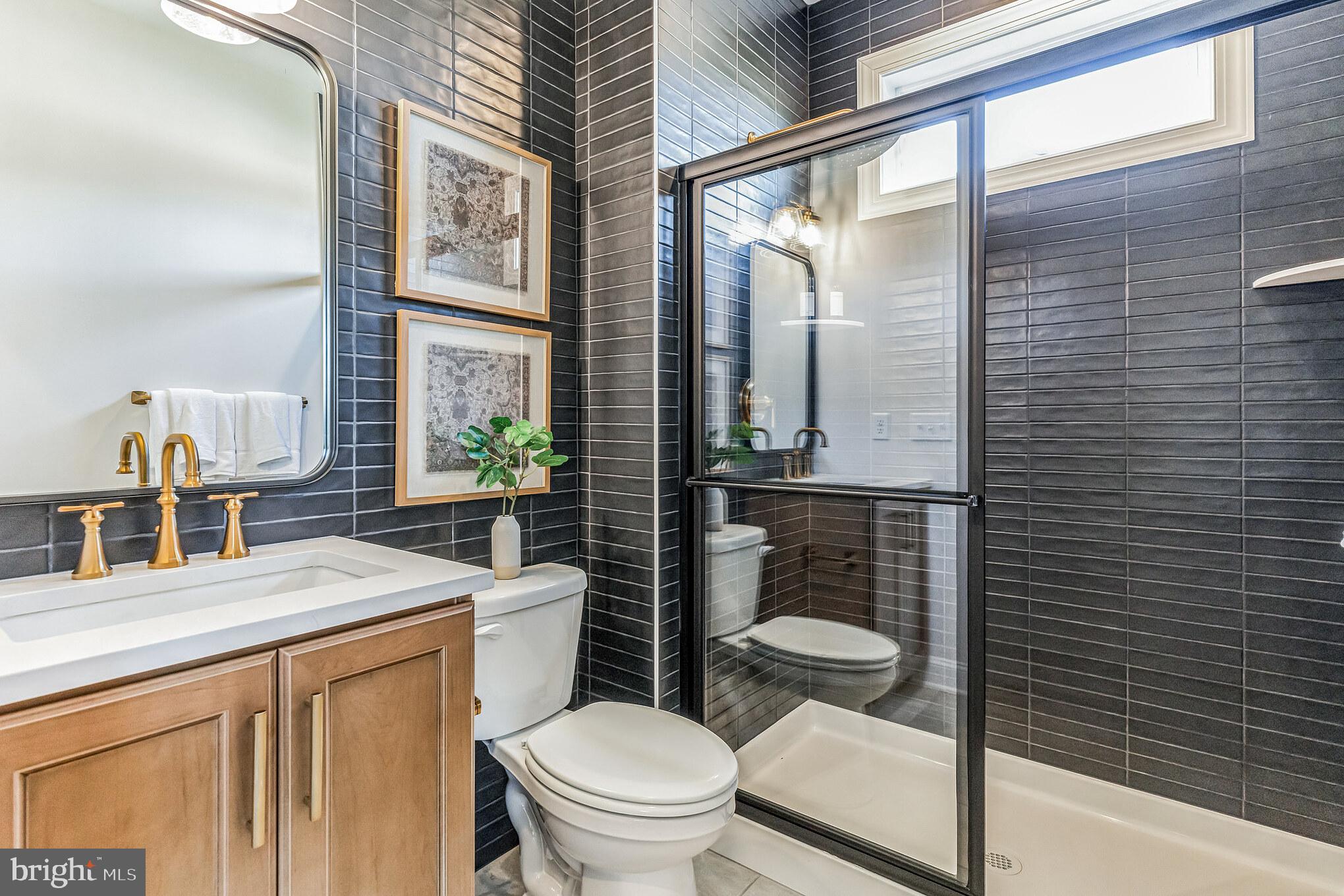 4441 Taviston Court East Emmaus, PA 18049 - Photo 10 of 49 a bathroom with a toilet a sink and a large mirror