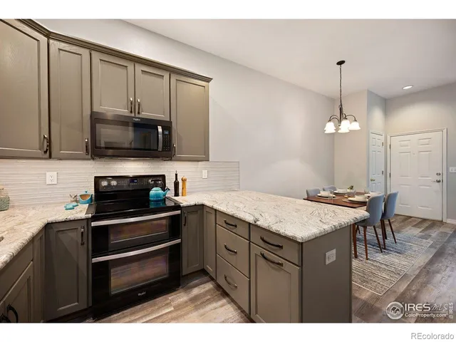 a kitchen with a sink stove and microwave