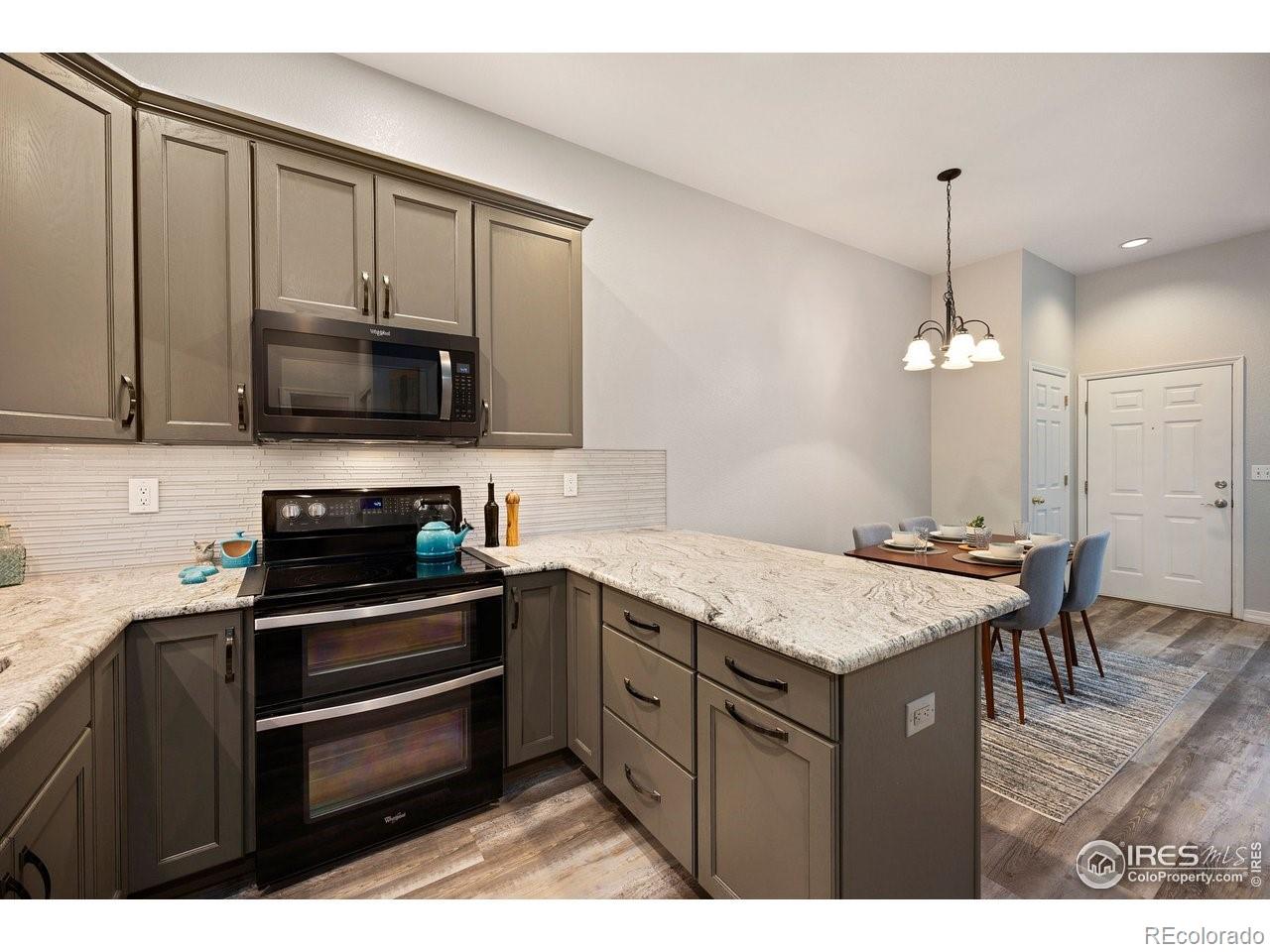 4500 Seneca Street, Unit 66 Fort Collins, CO 80526 - Photo 11 of 20 a kitchen with a sink stove and microwave