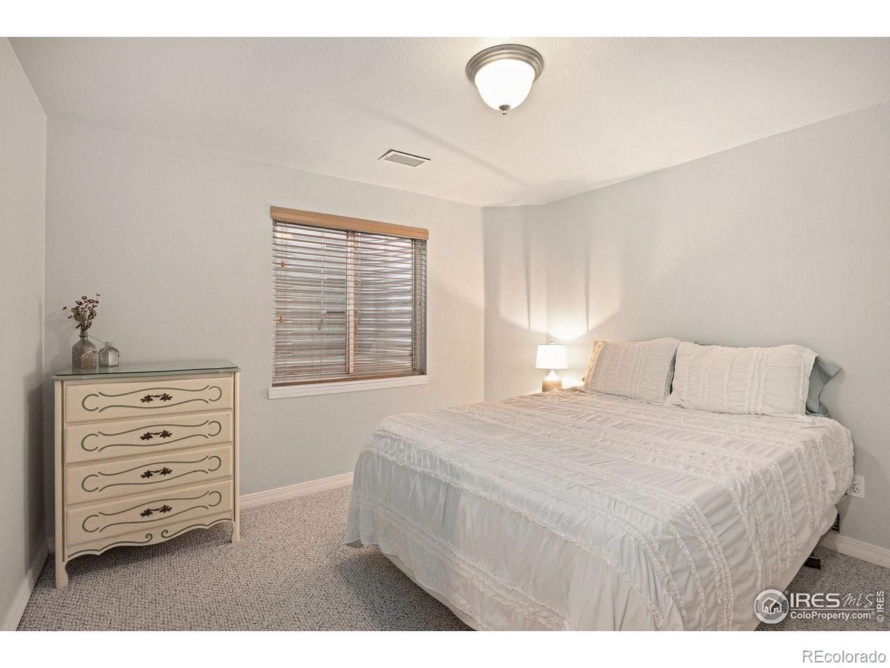 4500 Seneca Street, Unit 66 Fort Collins, CO 80526 - Photo 18 of 20 a bedroom with a bed and a dresser