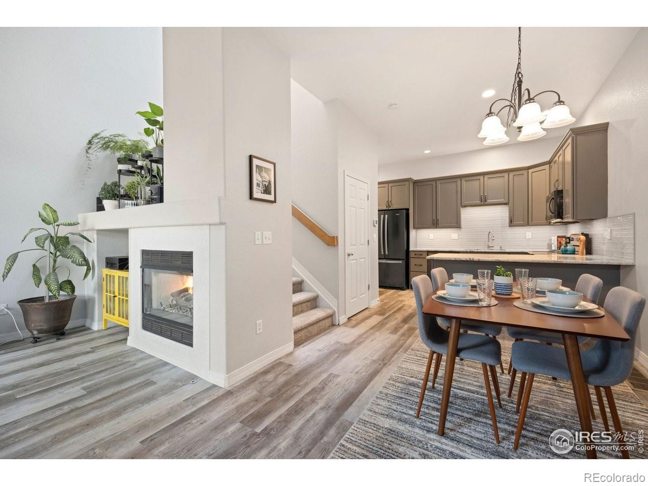 4500 Seneca Street, Unit 66 Fort Collins, CO 80526 - Photo 5 of 20 a view of a dining room with furniture wooden floor and a chandelier