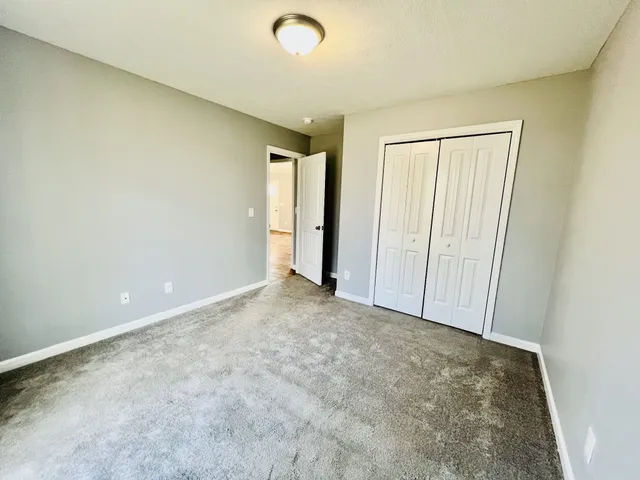 an empty room with closet area