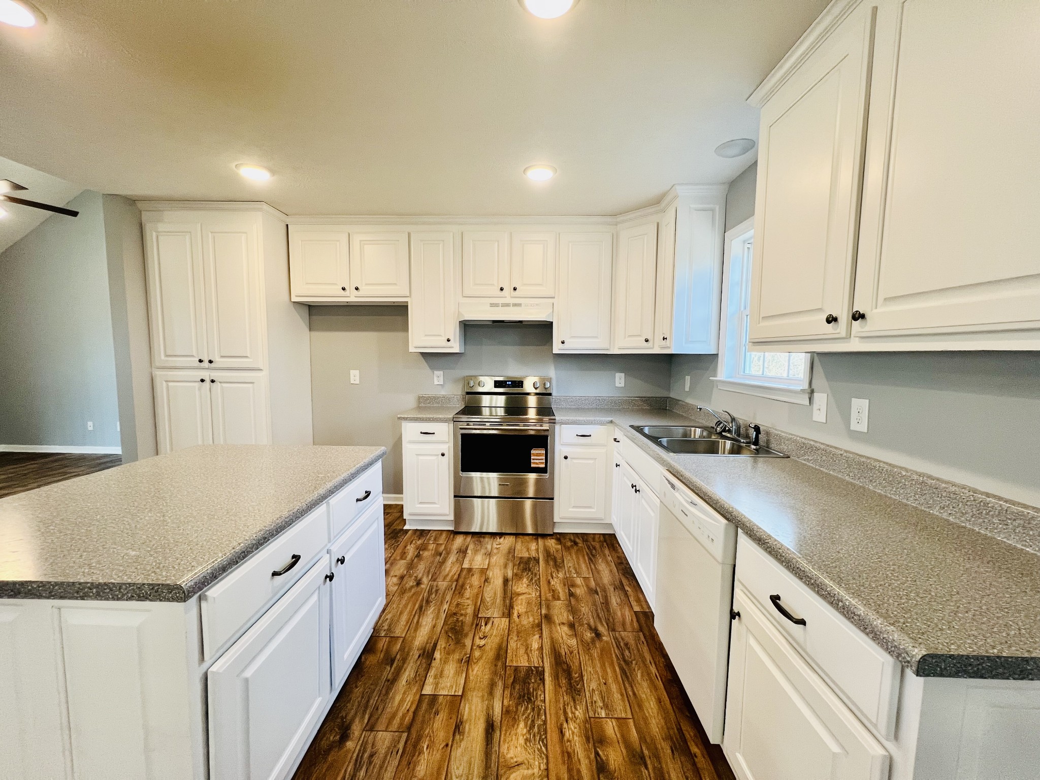 299 B Union Hollow Road Fayetteville, TN 37334 - Photo 6 of 27 a large kitchen with stainless steel appliances granite countertop a stove a sink and white cabinets