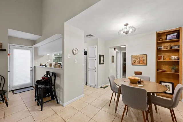 a view of a dining room with furniture and a chandelier
