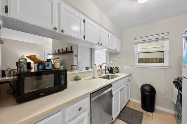 a kitchen with cabinets and appliances