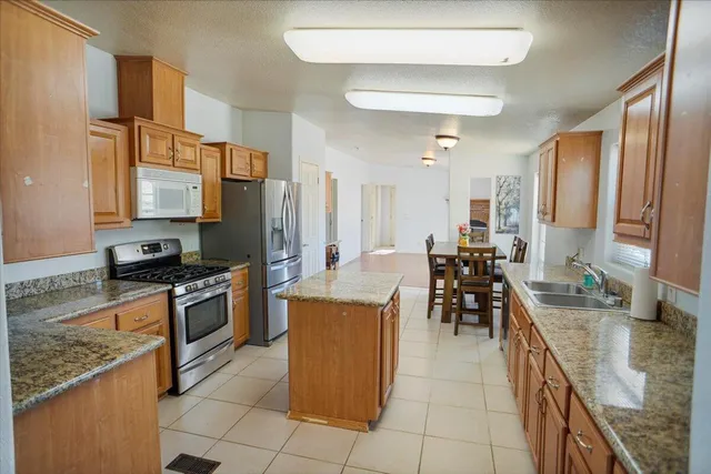 a kitchen with stainless steel appliances granite countertop a stove oven and a refrigerator