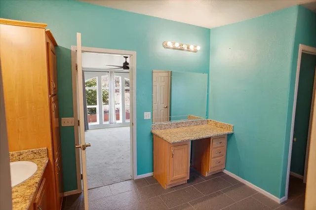 a view of a bathroom with a sink a mirror and a shower
