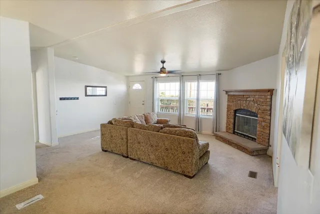a living room with furniture fireplace and window