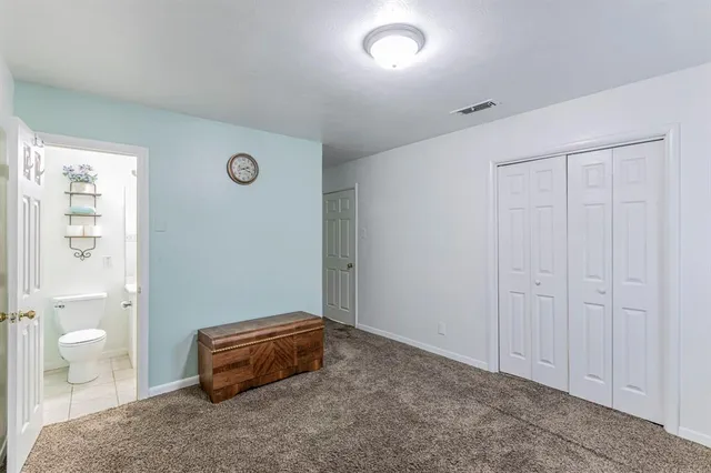 a spacious bedroom with a toilet