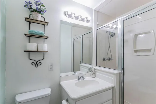 a bathroom with a sink a toilet and mirror