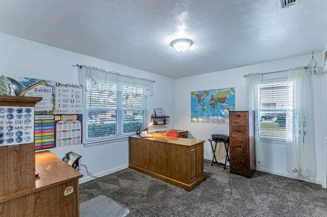 a living room with furniture a flat screen tv and a window
