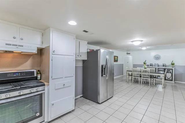 a kitchen with stainless steel appliances a refrigerator and a stove top oven