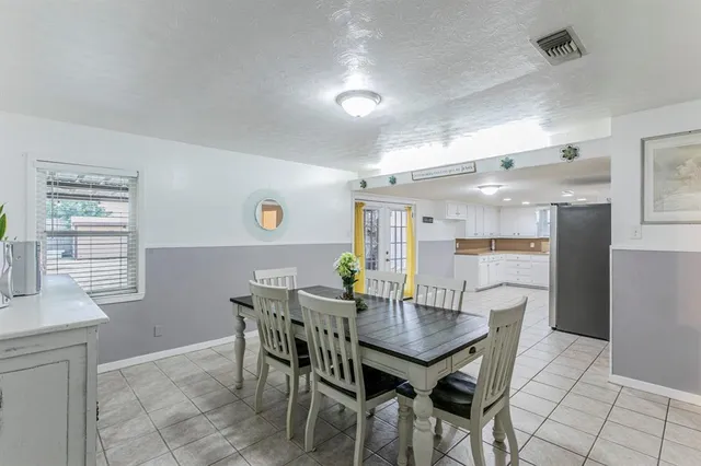 a dining room with furniture and window